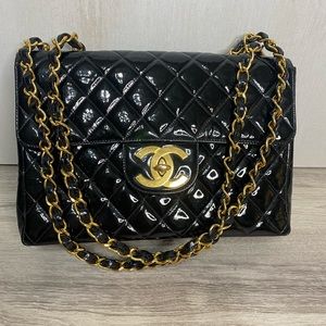 Used vintage jumbo classic black patent 24k gold hardware.